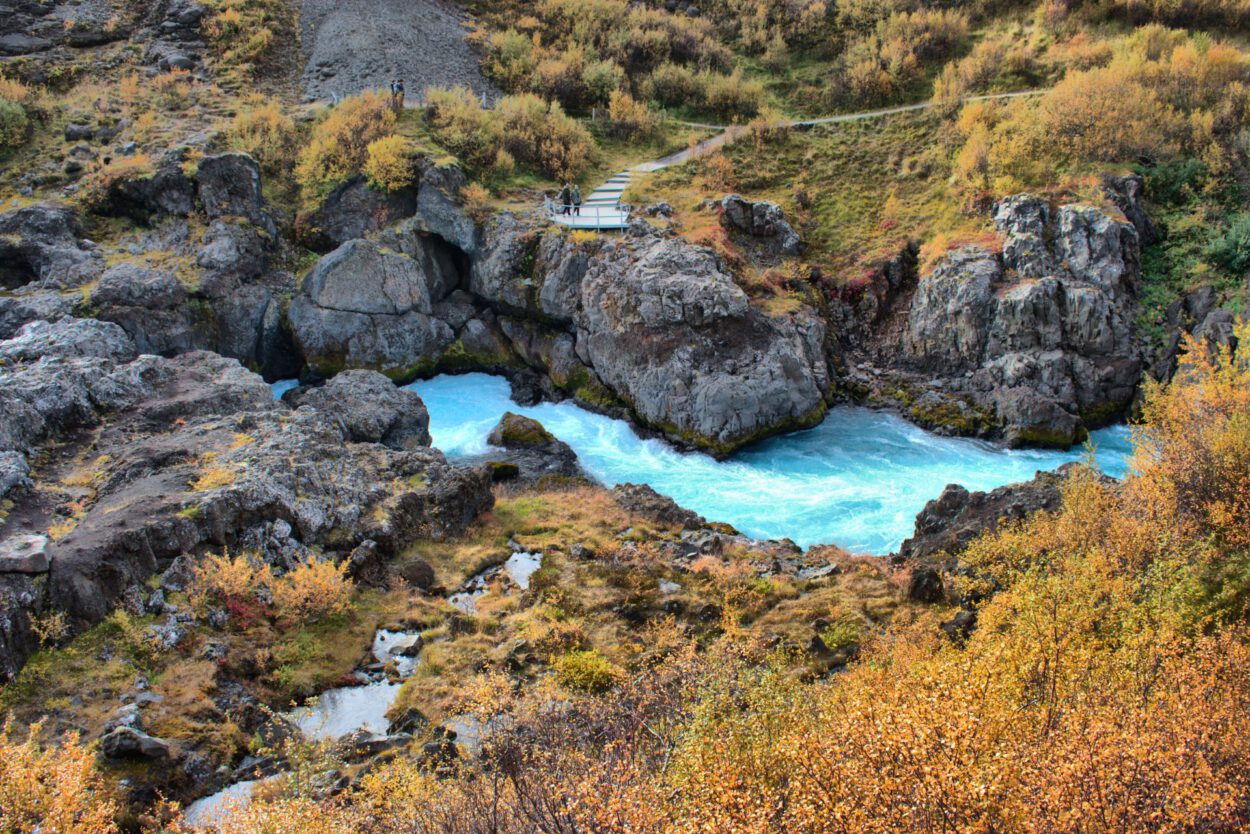 Ein blauer Fluss, der durch ein felsiges Gebiet fließt.
